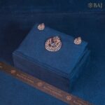 Azure Swirl diamond pendant set with blue center stone in 18k gold