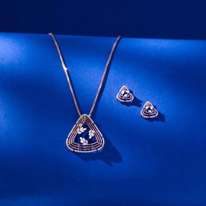 Floral Aura diamond pendent set with triangular frame and floral diamond motifs in 18k gold with matching earrings