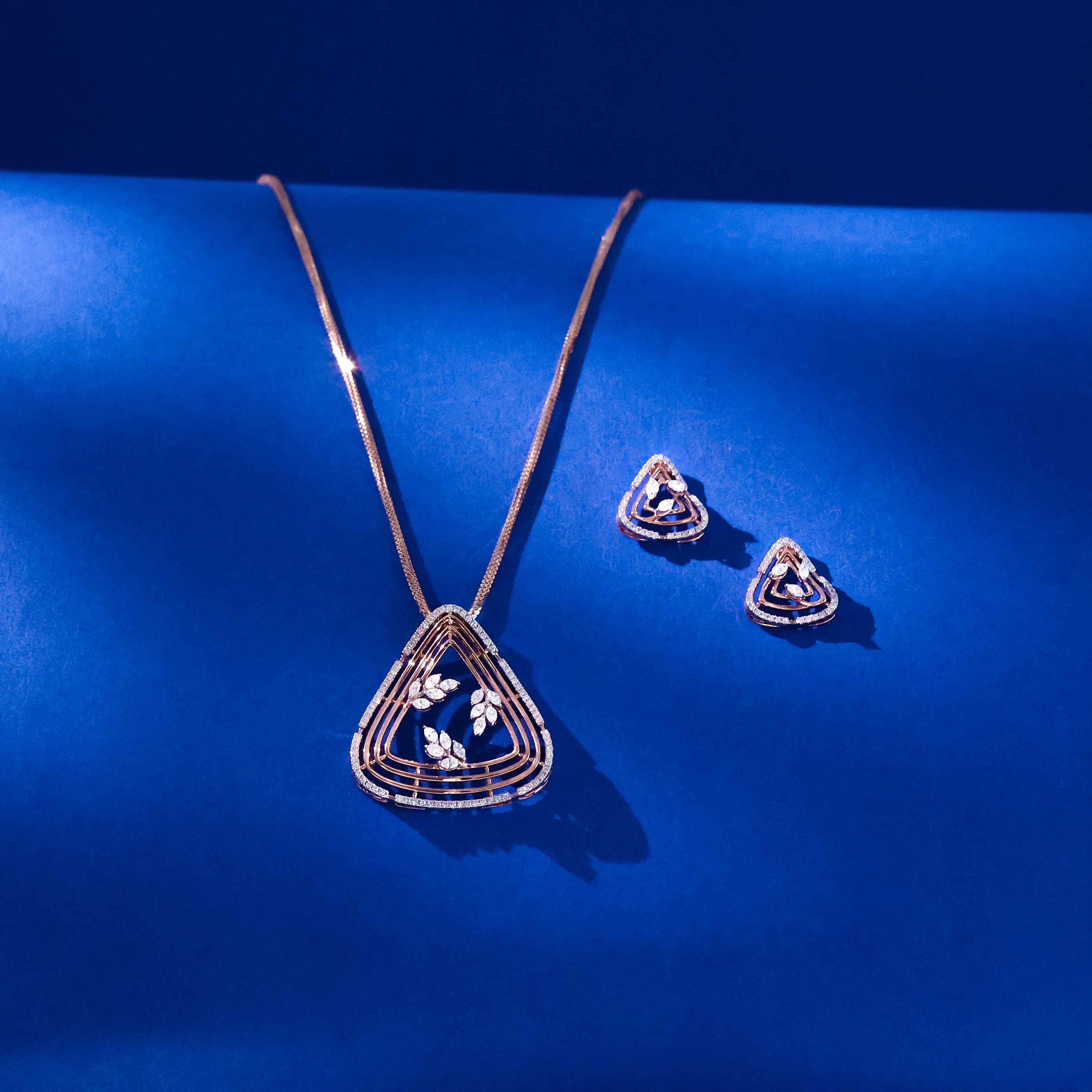 Floral Aura diamond pendent set with triangular frame and floral diamond motifs in 18k gold with matching earrings