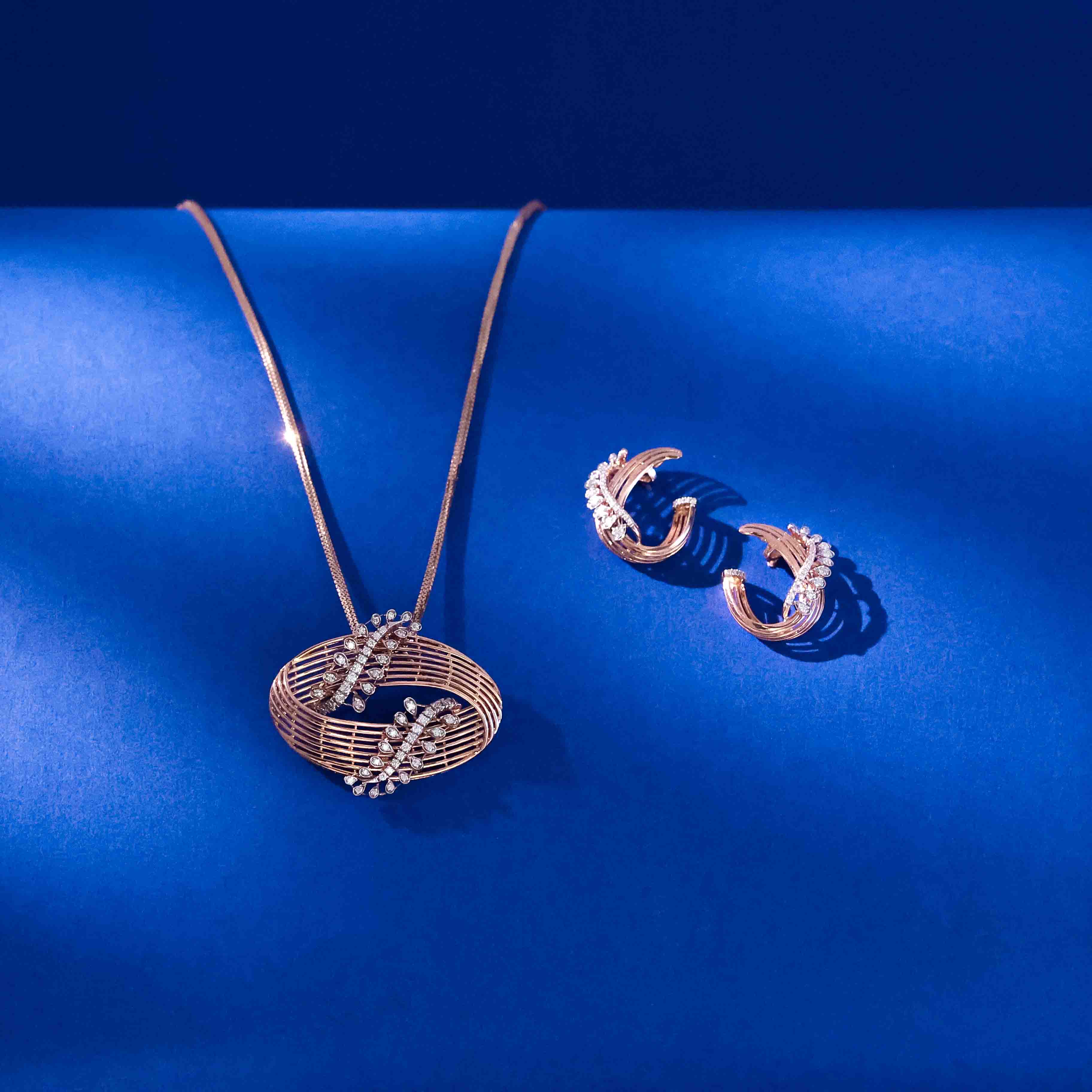 Orbit Bloom diamond pendent set with circular open frame design and floral diamond clusters in 18k gold with matching earrings