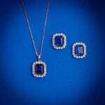 Diamond pendent set with emerald cut blue stone and matching earrings in 14k gold