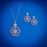 Diamond pendent set with hexagonal frame and floral diamond cluster with matching earrings in 14k gold