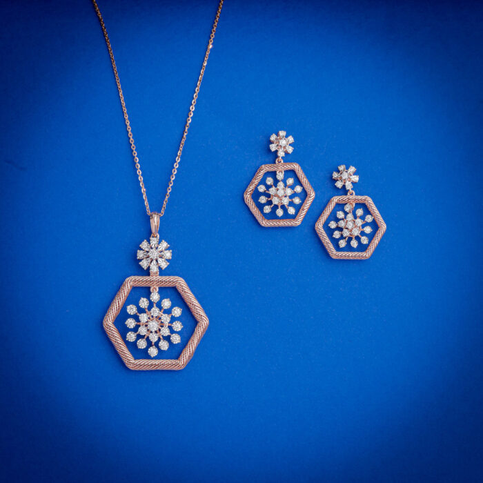 Diamond pendent set with hexagonal frame and floral diamond cluster with matching earrings in 14k gold