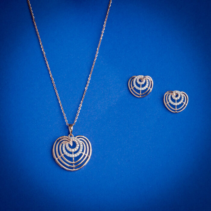 Diamond pendent set with layered heart design and matching earrings in 14k gold