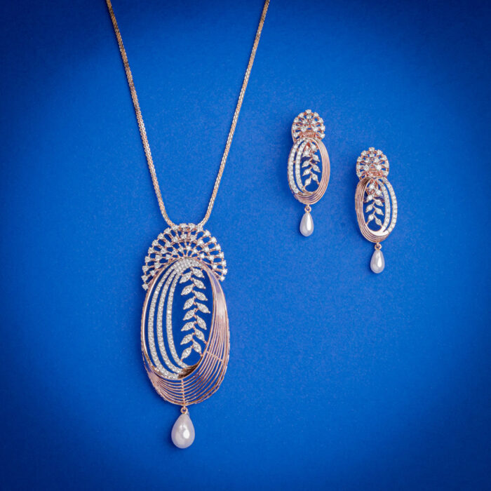 Diamond pendent set with elongated oval design, leaf diamond detailing and pearl drops with matching earrings in 14k gold