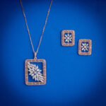 Diamond pendent set with rectangular frame and floral diamond cluster with matching earrings in 14k gold