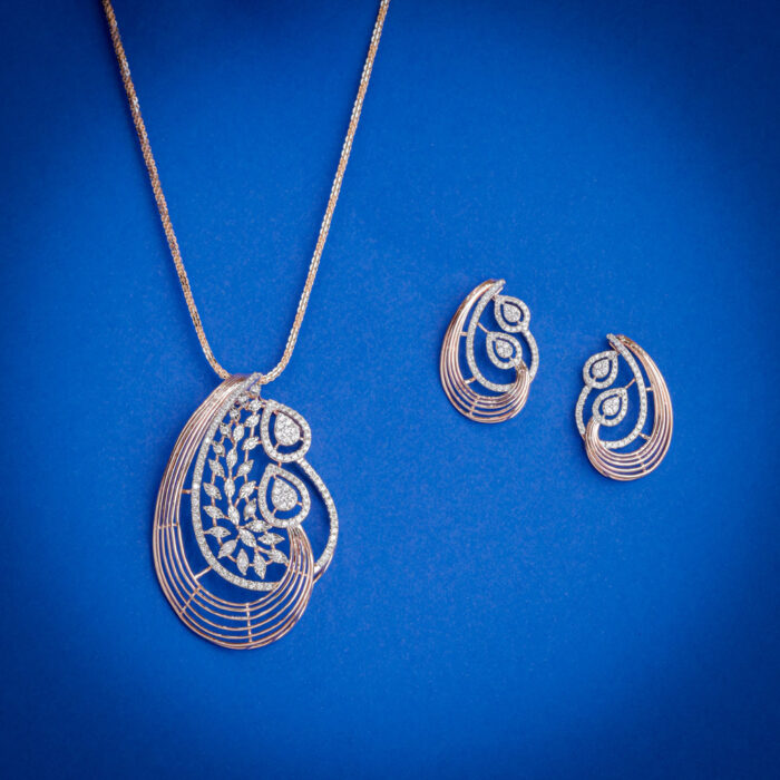 Diamond pendent set with paisley design and matching earrings in 14k gold