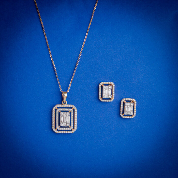 18kt gold diamond pendant set featuring a geometric rectangular design with layered brilliance and matching earrings.